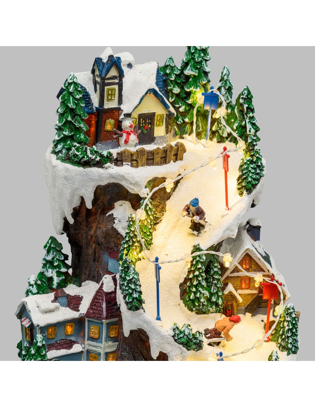 GIOSTRINE E VILLAGGI: vendita online Villaggio Innevato con Sciatori e Trenino in Movimento - Musica e LED H38cm in offerta