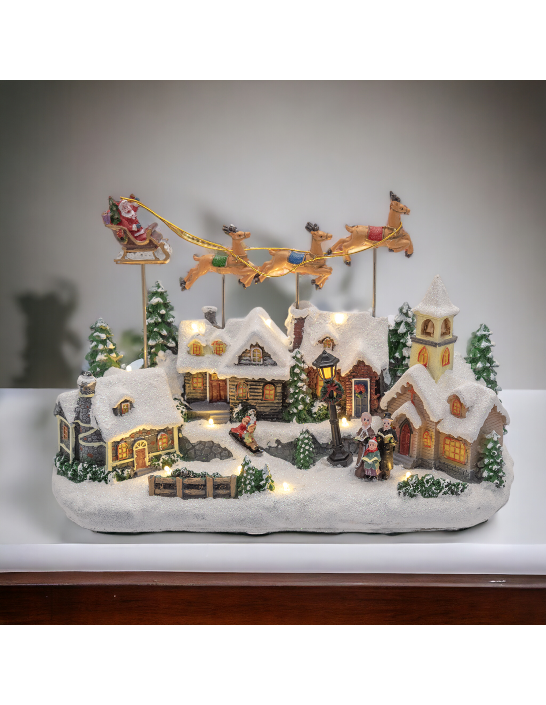 GIOSTRINE E VILLAGGI: vendita online Villaggio di Natale Innevato con Chiesa 34x23cm, Babbo Natale su Slitta Volante, Renne i...