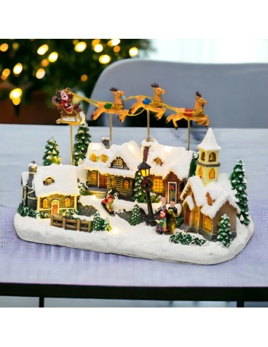 GIOSTRINE E VILLAGGI: vendita online Villaggio di Natale Innevato con Chiesa 34x23cm, Babbo Natale su Slitta Volante, Renne i...